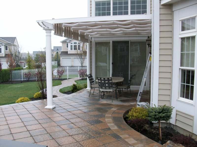 pergola with slide shade attached to house